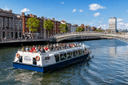River Liffey sightseeing cruise in Dublin passing city landmarks and bridges along the waterfront.